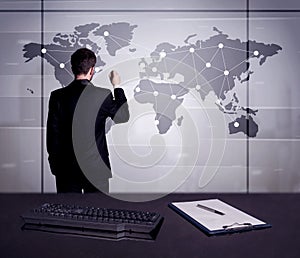 Business person drawing dots on world map