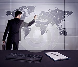 Business person drawing dots on world map