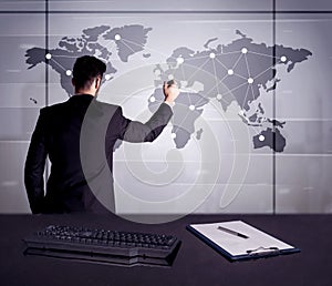 Business person drawing dots on world map