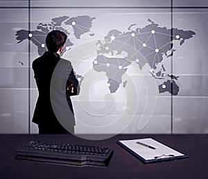 Business person drawing dots on world map