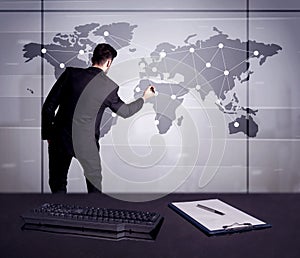 Business person drawing dots on world map