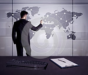 Business person drawing dots on world map