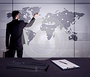 Business person drawing dots on world map