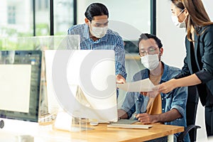 Business person with face mask dusciss work after office reopen