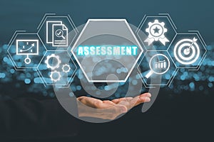 Business person hand holding assessment icon on virtual screen