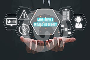 Business person hand holding incident management icon on virtual screen