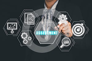 Business person hand touching assessment icon on virtual screen
