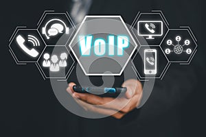 Business person hand using smartphone with VoIP icon on virtual screen