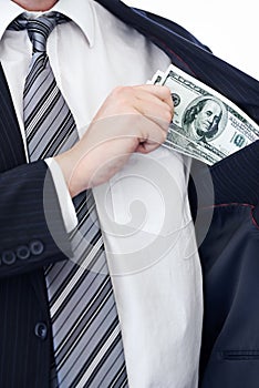 Business person, hands and money bribe in pocket for fraud, scam or secret on a white studio background. Closeup of