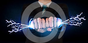 Business person holding electrical powered wires