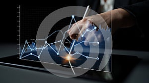 Business person analyzing financial data through digital screen with graphs and charts, using interactive technology for