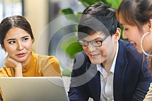 Business person man and woman teamwork meeting talking for job with laptop in office space.