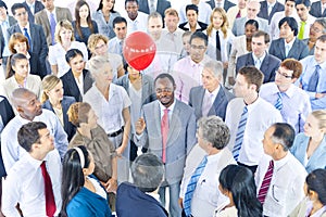 Business Person Standing Around the One Holding Red