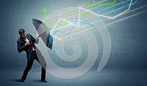 Business person with umbrella and stock market arrows concept