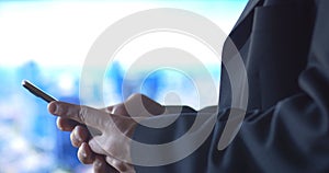 Business person using mobile cell phone technology city background