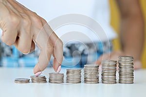 Business person walks fingers on steak with coins in direction of increasing profits