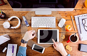 Business person working at office desk wearing smart watch