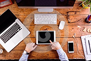 Business person working at office desk wearing smart watch