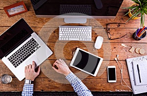 Business person working at office desk, wearing smart watch