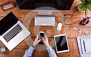 Business person working at office desk wearing smart watch