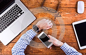 Business person working at office desk wearing smart watch