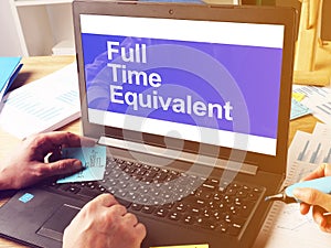 Business photo shows printed text FTE - Full Time Equivalent