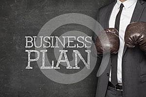 Business plan on blackboard with businessman