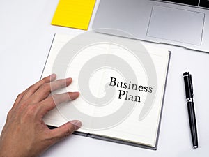 Business Plan written on open notebook on work desk