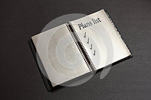 Business plans list in notebook