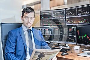 Business portrait of stock broker in traiding office.