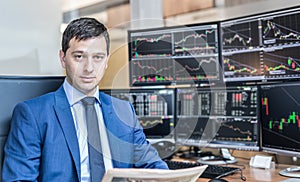 Business portrait of stock broker in traiding office.