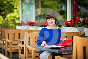 Business portrait of a woman who works as an accountant, economist with documents and a calculator