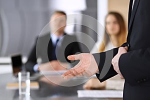 Business presentation. Businessman giving speech to colleagues and partners at corporate meeting or conference, close-up