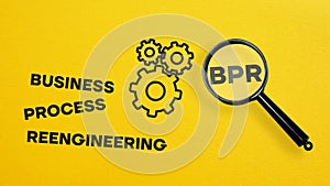 Business Process Reengineering BPR is shown using the text and photo of magnifying glass