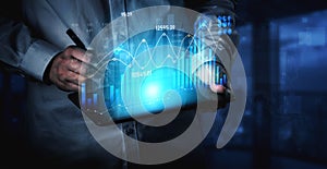 Business Professional Analyzing Data on Digital Tablet with Financial Charts and Graphs in Modern Office Environment