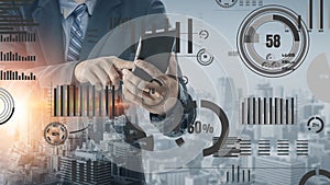 Business professional analyzing data on smartphone with digital graphs and city skyline in the background, representing