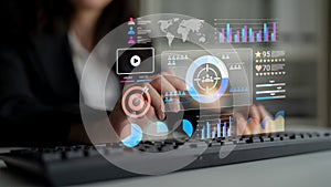 Business professional interacting with digital data visualization and analytics on futuristic interface while working on