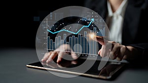 Business professional interacting with digital tablet, analyzing financial charts and graphs, showcasing data trends and