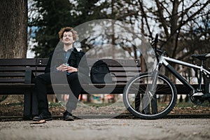 Business professional taking a break with his bicycle at the park