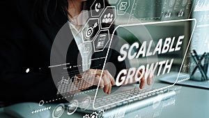 Business professional typing on keyboard with scalable growth concept and data visualization in a modern digital