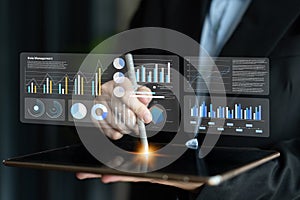 Business Professional Using Digital Tablet for Data Management with Interactive Graphs and Charts in a Modern Office