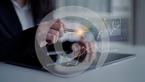 Business professional analyzing financial data on tablet with graphs, charts, and global statistics in modern workspace