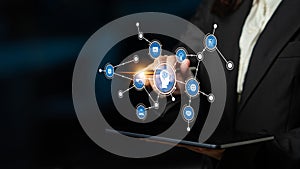 Business Professional Using Tablet to Interact with Digital Network Interface Featuring Technology Icons and Data
