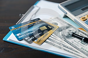 Business professional at work desk using a credit card calculator to manage finances, plan budgets, and analyze financial data