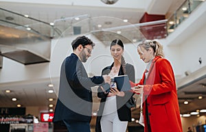 Business professionals conversing in a shopping mall