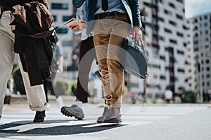 Business professionals crossing the street in a bustling city district