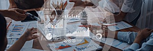 Collaborative Data Analysis with Charts, Graphs and Digital Visuals on Table Surrounded by Business Professionals