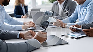 Business professionals engage with laptops and tablets while exploring cloud computing technology in a modern office
