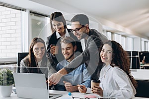 Business professionals. Group of young confident business people analyzing data using computer while spending time in the office