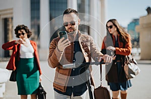 Business professionals using technology during a break in a modern city setting